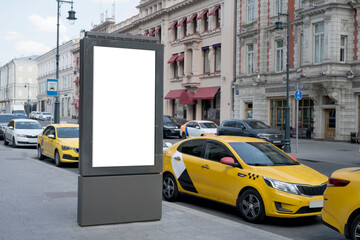 Blank advertising billboard in the city center next to the road. City format