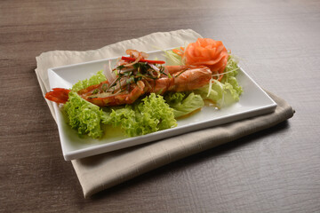 grilled bbq big tiger prawn seafood with Thai spicy chilli sauce on wood background asian halal menu