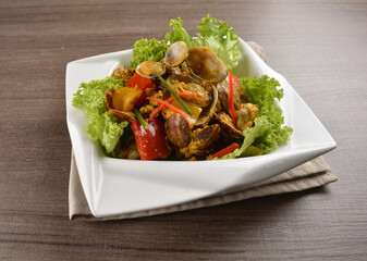 stir fried flower clam shell seafood with sambal spicy chilli sauce on wood background asian halal menu