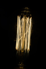 Incandescent lamp on a dark background.