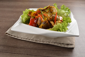 stir fried flower clam shell seafood with sambal spicy chilli sauce on wood background asian halal menu