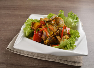 stir fried flower clam shell seafood with sambal spicy chilli sauce on wood background asian halal menu