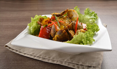 stir fried flower clam shell seafood with sambal spicy chilli sauce on wood background asian halal menu