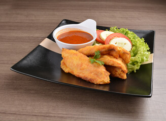 deep fried crispy fish fillet seafood with sambal spicy chilli sauce in bowl on wood background asian halal menu