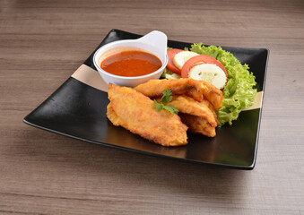 deep fried crispy fish fillet seafood with sambal spicy chilli sauce in bowl on wood background asian halal menu
