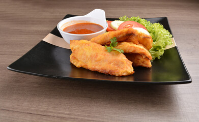 deep fried crispy fish fillet seafood with sambal spicy chilli sauce in bowl on wood background asian halal menu