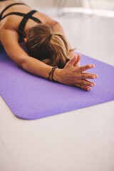 Obraz na płótnie Canvas Woman doing balasana yoga at gym