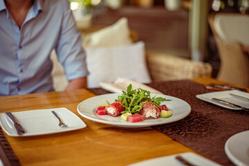 Salad of red fish Salmon, roll with Kamchatsky crab, arugula, avocado, sesame and oil