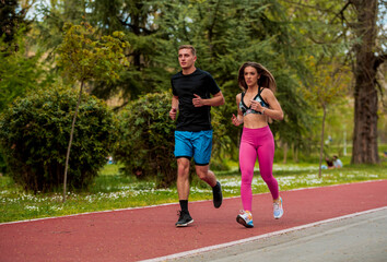 Young athtletes in the city running in park