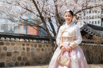 Korean lady in hanbok dress costume smile in an ancient Gyeongbokgung palace in Seoul city - 445357166