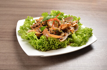 stir fried flower clam shell seafood with sambal spicy chilli sauce on wood background asian halal menu