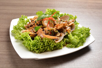 stir fried flower clam shell seafood with sambal spicy chilli sauce on wood background asian halal menu