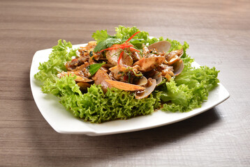 stir fried flower clam shell seafood with sambal spicy chilli sauce on wood background asian halal menu