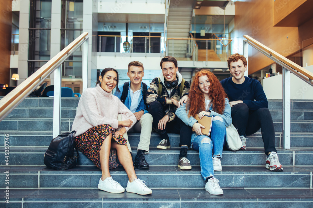 Wall mural college students sitting on steps after class