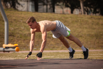 Male sportsman is training his extreme push ups