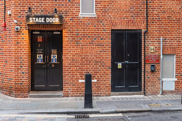 Stage Door, London. A securely closed stage door at the rear of a theatre in the heart of London's West End theater district.
