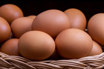 Fresh chicken eggs in a wicker basket. Close-up