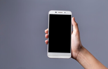 Modern smartphone with cut screen in hands, mobile isolated on gray background, mockup