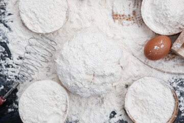 sprinkling white flour over dough on kitchen background, Baking Cooking Ingredients Flour Eggs and Butter 