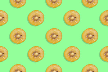 Seamless pattern of juicy ripe kiwi slices on a green background