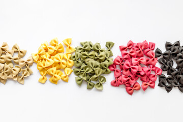 Heaps of pasta - various colors farfalle pasta, top view