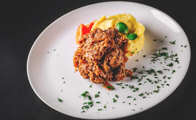 Fried liver with onion and mashed potatoes on white plate