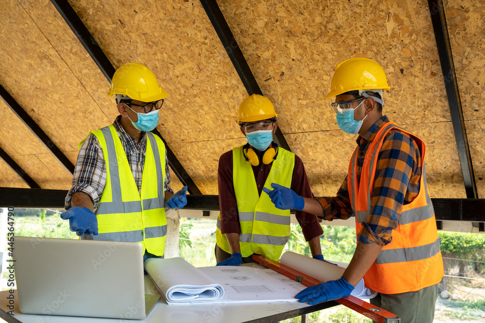 Poster engineers or architect holding a pen with drawings in construction on blueprints in construction sit