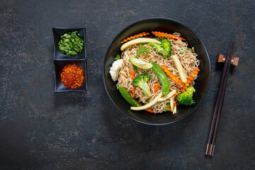 Vegetarian Noodles Thai vegetarian vegetables noodles in a dark background, top view. Vegetarian food in asian style. Copy space
