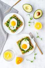 Sandwich with eggs avocado cream and spinach, top view