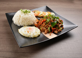 stir fried minced chicken meat in spicy chilli  sauce with white rice and fried egg on wood background asian halal set lunch menu