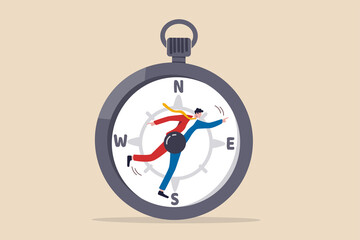 Decision making to lead company to success direction, leadership or determination, career guidance or job opportunity concept, businessman at the center of magnetic compass pointing to guide direction © Nuthawut