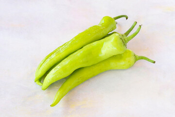 Green pepper on a white wooden background