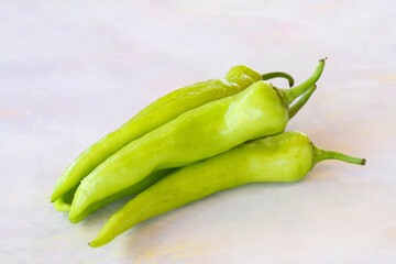 Green pepper on a white wooden background
