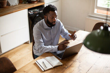 African American businessman working from home on a video call 