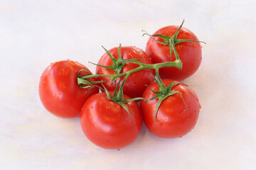Bunch tomatoes on a white wooden background