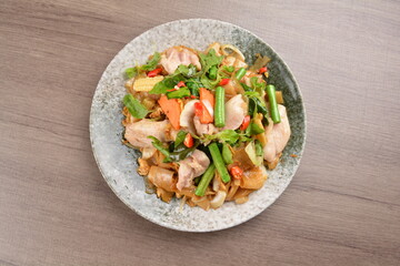 wok fried noodle phad Thai with chicken meat on wood background asian halal set lunch menu