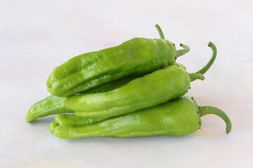 Green pepper on a white wooden background