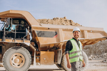 Male worker with bulldozer in sand quarry - obrazy, fototapety, plakaty