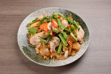 wok fried noodle phad Thai with chicken meat on wood background asian halal set lunch menu