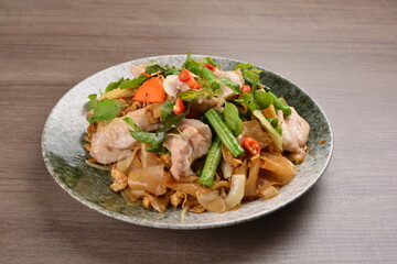 wok fried noodle phad Thai with chicken meat on wood background asian halal set lunch menu