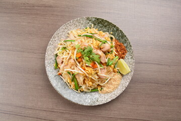 wok fried noodle phad Thai with chicken meat on wood background asian halal set lunch menu