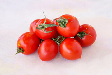 Cherry tomatoes on a white wooden background