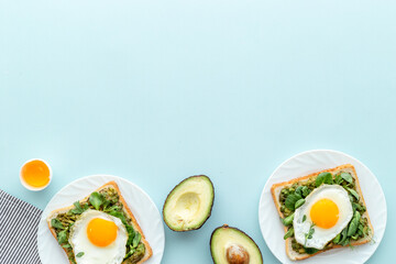 Eggs and avocado with spinach on toasted bread. Top view