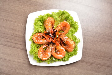 stir fried bbq tiger prawn seafood with Thai spicy chilli sweet sauce on wood background asian halal set lunch menu