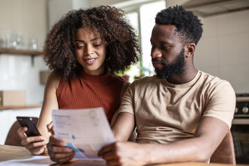African american couple paying bills together