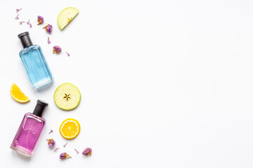 Perfume bottles with flowers leaves and fruits. Overhead view
