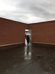 man walking on the street with umbrella