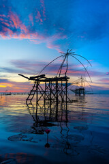silhouette scenery of sunrise at pakpra phatthalung with thai traditional fishing trap