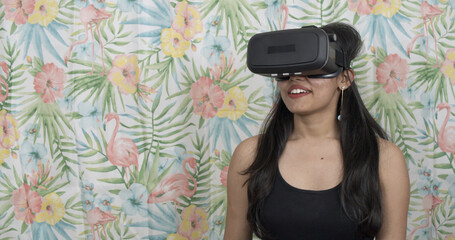 Young Indian woman smiling while trying a VR headset