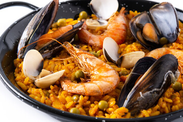 Traditional spanish seafood paella isolated on white background. Close up